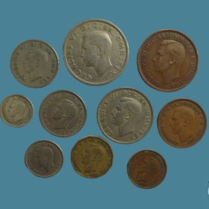 May include: A collection of ten silver and copper coins featuring the profile of King George VI. The coins are arranged in a circular pattern on a blue background.