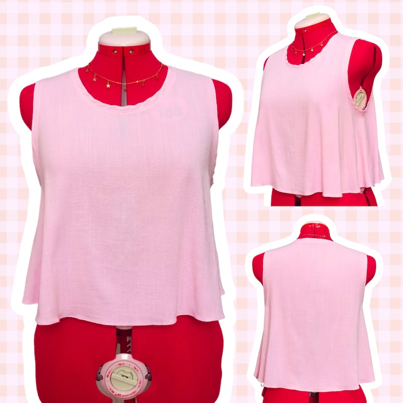 May include: A sleeveless pink crop top with a rounded neckline. The top is made of a soft, textured fabric and has a slightly flared hem.