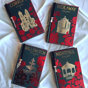 May include: Four hardback books with dark green covers, gold lettering, and red floral designs. Each book features a different title: "Corrupt," "Hideaway," "Killswitch," and "Nightfall." The books have black ribbon bookmarks with silver charms.