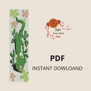 May include: A green lizard bookmark with a floral design. The bookmark features a pixelated lizard with a light green body and a pink nose. The text "PDF" and "INSTANT DOWNLOAD" are also visible.