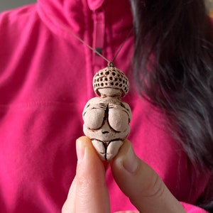 Ceramic pendant with Willendorf Venus. Clay pendant of the mother goddess.