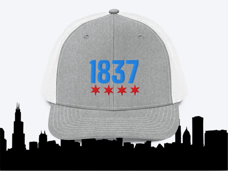 May include: Gray and white trucker hat with blue and red embroidery. The hat features the number "1837" and three red stars.