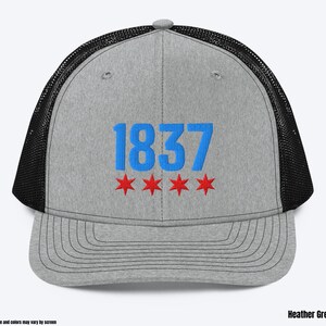 May include: A heather grey and black trucker hat with the number "1837" embroidered in blue and three red stars.
