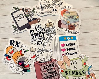 May include: A set of ten colorful stickers featuring book-themed designs. The stickers include phrases like "I like books more than people", "I like my books spicy & my coffee icy", "Crying over fictional characters", "Single, Taken, Reading", "I'm a Kindle Girlie", and "RX for escaping reality".