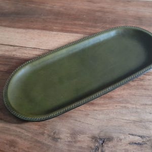 An attractive handcrafted leather decorative multifunctional storage / valet tray, keeping your daily accessories in one place.