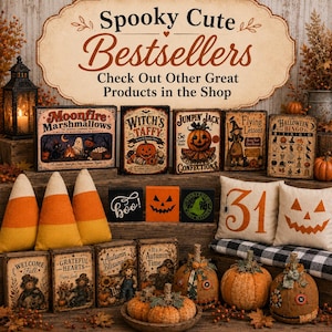 May include: A collection of Halloween-themed decor featuring wooden signs with text like Moonfire Marshmallows, Witch's Taffy, and Halloween Bingo, alongside plush candy corn, decorative pumpkins, and throw pillows with the number 31 and a jack-o'-lantern.