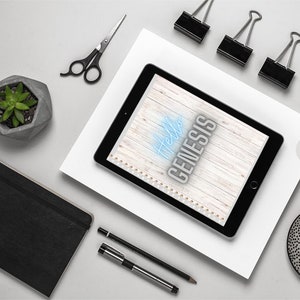 May include: A white woodgrain background with the text "Hello Genesis" in blue neon lettering. The background is on a tablet computer with a black frame.