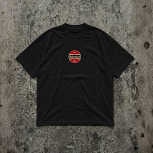Pu&ograve; includere: T-shirt nera con logo rotondo con il marchio Heineken in bianco e rosso, con una stella rossa in alto. La parola "bier" &egrave; scritta in rosso sotto il logo. La maglietta &egrave; realizzata in materiale morbido.