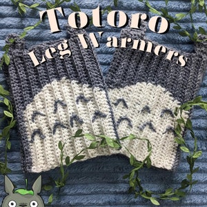 May include: A pair of crocheted leg warmers featuring a Totoro design. The leg warmers are grey and white with a pattern of small white triangles. The text "Totoro Leg Warmers" is written in black letters on a white background.