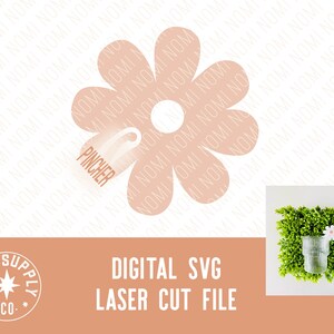 May include: A digital SVG laser cut file of a pink flower with a circle in the center. The file is for crafting and can be used to create a variety of projects.