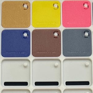 May include: A color chart with 10 different colored squares. The squares are arranged in two rows of five. The colors are black, red, white, brown, yellow, pink, gray, orange, green, and blue.