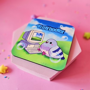 May include: Square coaster with a cartoon pigeon next to a retro computer, set against a green field and blue sky background. The text "on my hooter" is printed on the top. Bubbles are also included in the design.