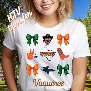 May include: A white t-shirt featuring a graphic print with four bows in green and orange, a mascot head, a peace sign hand gesture with the text 's UP, a map of Texas with UTRGV text, an orange cowboy boot, a rider on horseback, and the word Vaqueros.