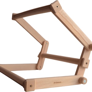 May include: A handmade wooden sign with the text "Welcome" in a handwritten style. The sign is painted white with a distressed finish, and a small green leaf is attached to the top. The sign measures approximately 30 cm wide.