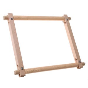 May include: A square wooden embroidery frame featuring two horizontal rods with the text "TURN TO TENSION" and "EASY-CLIP" printed on them. The frame is constructed with four light-colored wooden pieces connected by metal screws at each corner.