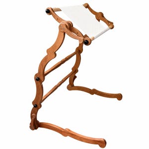 May include: A wooden embroidery floor stand featuring a curved frame with adjustable joints and black knobs. The top section holds a rectangular wooden frame with a taut white fabric panel stretched across it for needlework projects.