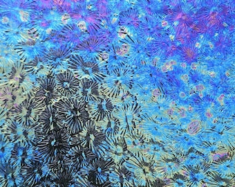 May include: A textured glass surface featuring a repeating pattern of small, star-shaped or floral-like indentations. The glass displays a gradient of colors, transitioning from deep black and dark gray at the bottom to vibrant blue and purple at the top.