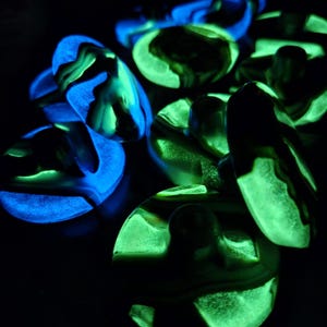 May include: A white ceramic mug with a black handle and the text "But First, Coffee" in a handwritten style. The mug is on a white surface. The mug is approximately 4 inches tall.