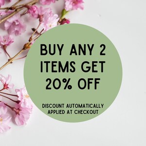 May include: A green circle with white text that reads "BUY ANY 2 ITEMS GET 20% OFF" and "DISCOUNT AUTOMATICALLY APPLIED AT CHECKOUT". The circle is surrounded by pink cherry blossoms.