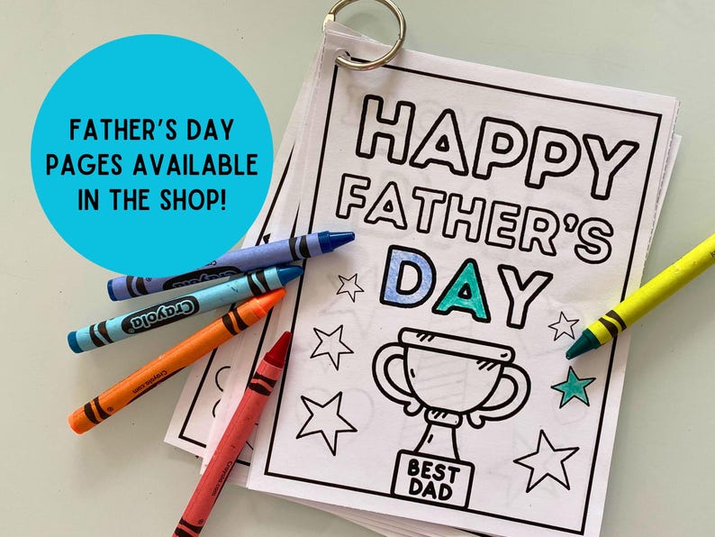 May include: A black and white coloring page with the text "Happy Father's Day" and a trophy with the text "Best Dad". The page is surrounded by crayons.
