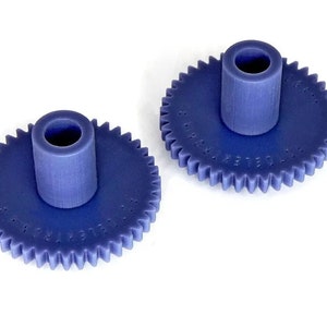 May include: Two blue plastic gears with a central hole. The gears have 30 teeth and the text "MADE IN USA" is printed on the face of each gear.