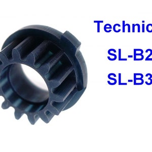 Może przedstawiać: Zębatka z tworzywa sztucznego w kolorze czarnym z 12 zębami. Zębatka jest oznaczona "Technics SL-B2 SL-B3".
