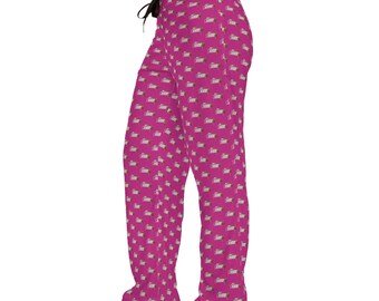 May include: Magenta pyjama trousers featuring a repeating pattern of white and green designs. The trousers have a drawstring waist and a relaxed fit. The fabric appears soft and comfortable, suitable for sleepwear.