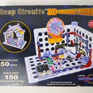 May include: A Snap Circuits 3D Illumination kit box. The box features a circuit board with various components, including a light tunnel and a house model. The box states it contains over 50 parts and allows for over 150 exciting projects. Ages 8-108.