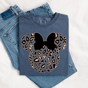 May include: A set of three ceramic mugs with a speckled, matte finish. The mugs are in shades of cream, light gray, and dark gray. Each mug has a simple, minimalist design and a rounded handle.