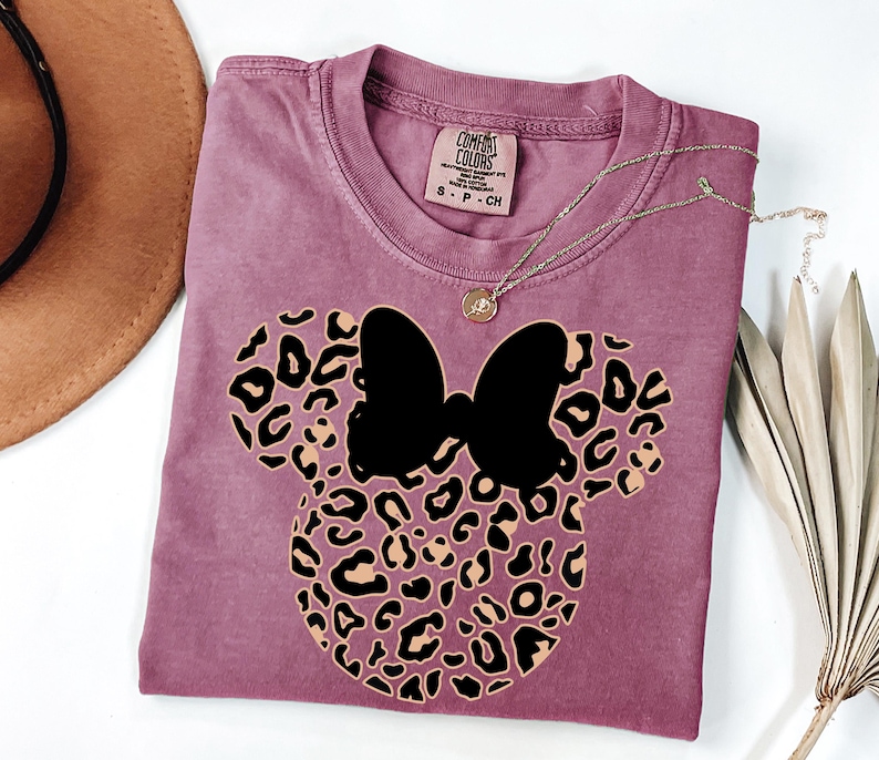 May include: A set of three ceramic mugs with a speckled, matte finish. The mugs are in shades of cream, light gray, and dark gray. Each mug has a simple, minimalist design and a rounded handle.