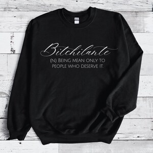 May include: Black sweatshirt with the word "Bitchilante" in a cursive font. Below the word is the definition: "(N) BEING MEAN ONLY TO PEOPLE WHO DESERVE IT."