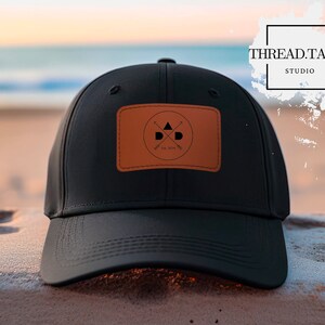 May include: Black baseball cap with a brown leather patch featuring a logo with a triangle, two arrows, and the text "THREAD.TALKS STUDIO" and "EST. 2014".