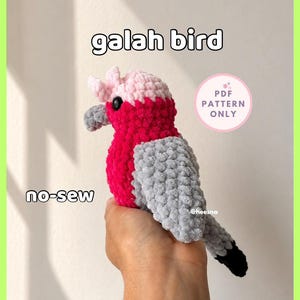 May include: A crochet galah bird plush toy featuring a light pink head crest, a vibrant dark pink chest, and grey wings with a black-tipped tail. The text on the image reads galah bird, no-sew, and PDF PATTERN ONLY. The bird has a small grey beak.