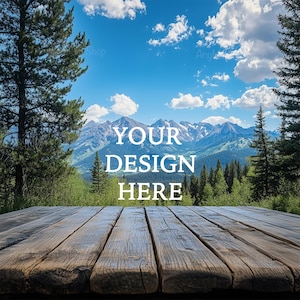 May include: A wooden table top with a view of a mountain range in the background. The mountains are covered in snow and the sky is blue with white clouds. The text "YOUR DESIGN HERE" is superimposed on the image.