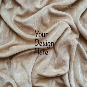 Puede incluir: Primer plano de una tela de terciopelo beige con el texto "Your Design Here" impreso en negro.
