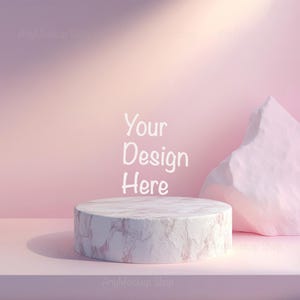 May include: A white marble pedestal sits on a pink surface with a pink cloud-like shape in the background. The text "Your Design Here" is written in white on a pink background.