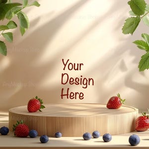 May include: A wooden round platform with a light brown finish sits on a light beige surface. The platform is surrounded by blueberries and strawberries. The background is a light beige wall with shadows from sunlight. The text "Your Design Here" is written in red on the wall.