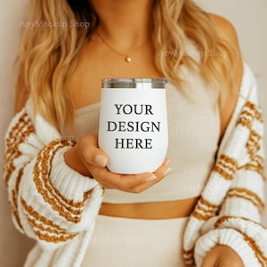 May include: A white stainless steel tumbler with a silver lid. The tumbler has the text "YOUR DESIGN HERE" printed on it.