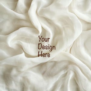May include: White fabric background with the text "Your Design Here" in brown.