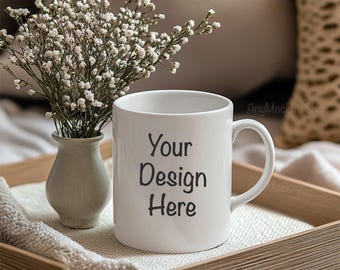 May include: White ceramic mug with a black handle and the text "Your Design Here" on the front. The mug is sitting on a wooden tray with a white cloth napkin.