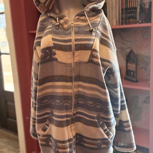 May include: A white ceramic mug with a black handle and the text "But First, Coffee" in a handwritten style. The mug is on a white surface. The mug is 4 inches tall.