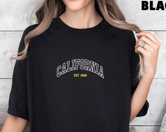 May include: Black oversized t-shirt with white text that reads "CALIFORNIA EST 1850".