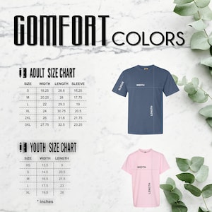 May include: A size chart for adult and youth t-shirts. The chart shows the width, length, and sleeve length in inches for each size. The chart is accompanied by images of a blue t-shirt and a pink t-shirt.
