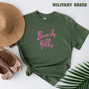 May include: A green t-shirt with the words "Beverly Hills" in pink lettering.