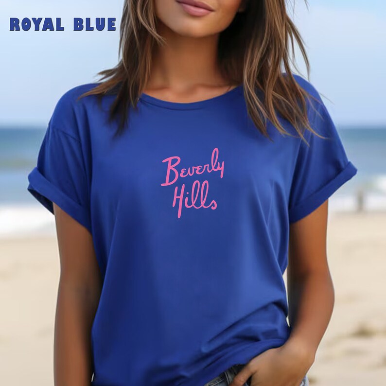 May include: A royal blue t-shirt with a pink "Beverly Hills" graphic.