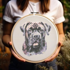 May include: A cross-stitch embroidery hoop with a black and white image of a dog's head. The dog has a short, black muzzle and a wrinkled forehead.