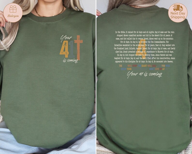 May include: Green sweatshirt with a vintage-style graphic of the number 41 and a cross. The text "Your 41 is coming" is printed below the graphic. The back of the sweatshirt features a text passage about the number 40 in the Bible.