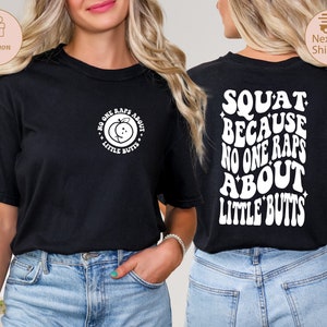 May include: Black t-shirt with a white graphic on the front that says "No one raps about little butts" and a white graphic on the back that says "Squat because no one raps about little butts".