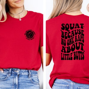 May include: Red t-shirt with a black graphic on the front that says "No one raps about little butts" and a black graphic on the back that says "Squat because no one raps about little butts".
