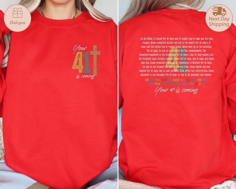 May include: Red long-sleeved sweatshirt with a rainbow-coloured graphic that says "Your 41 is coming" and a cross. The back of the sweatshirt has a text description about the number 40 in the Bible.